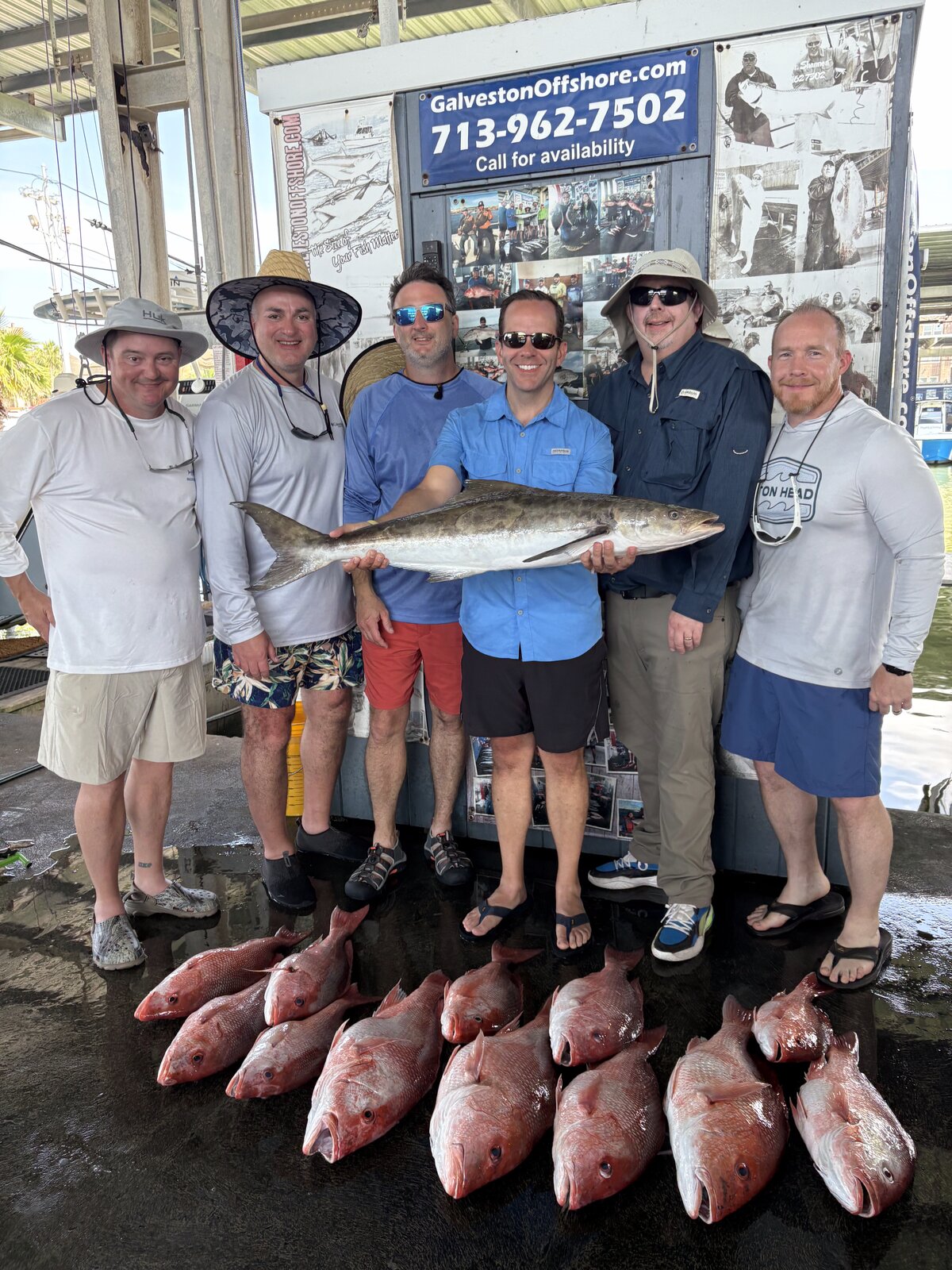 Six anglers at the Galveston Offshore dock with a kingfish and a limit of red snapper from a federal offshore charter