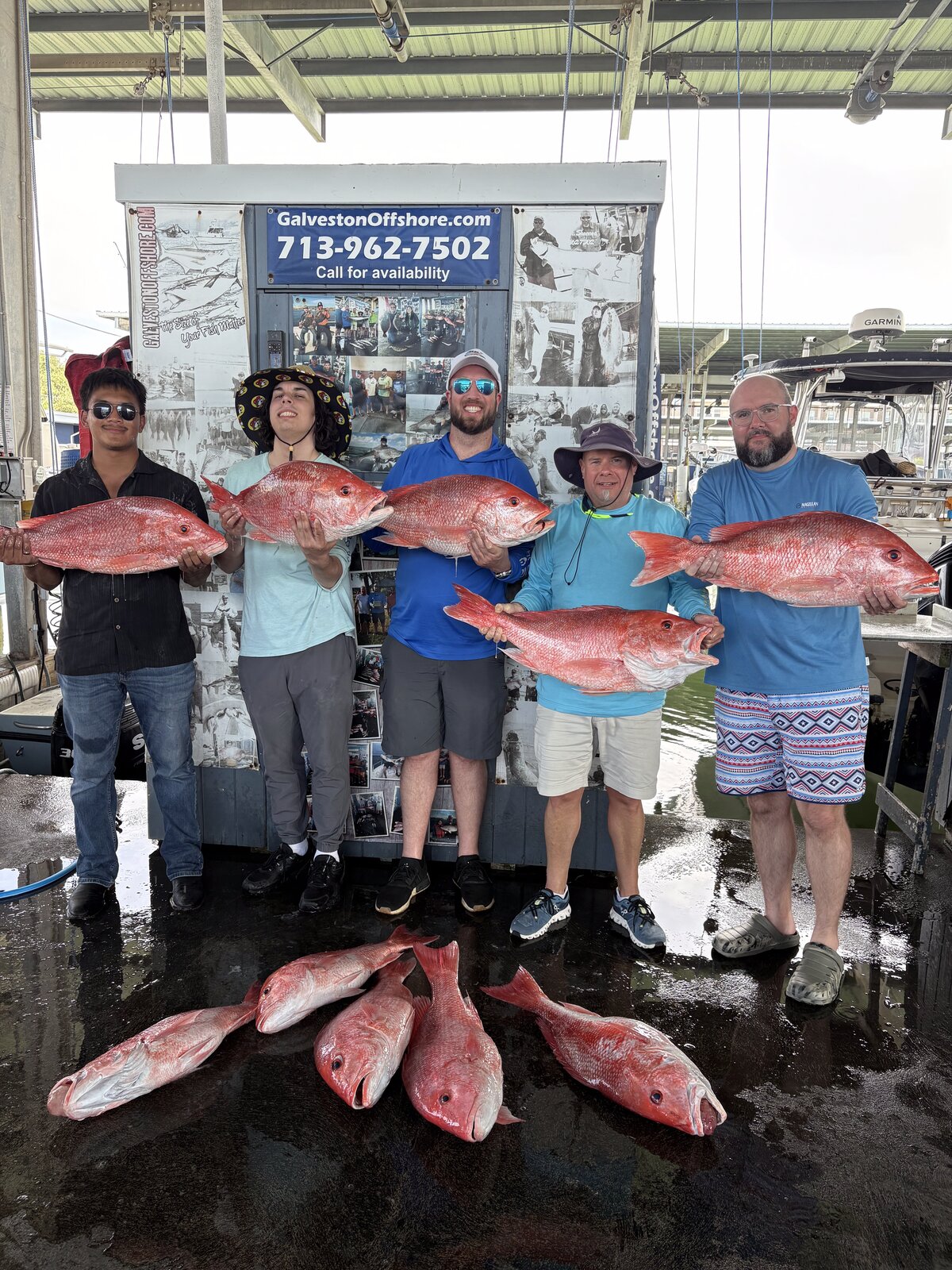 Five anglers at the Galveston Offshore sign holding red snapper after a federal offshore charter
