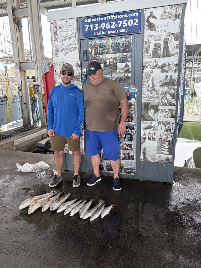 Two anglers at the Galveston Offshore dock with a limit of speckled trout from a jetty trip