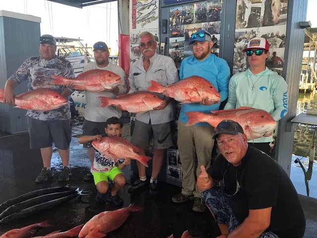 A group of anglers with their red snapper catch at the dock at Galveston Yacht Basin