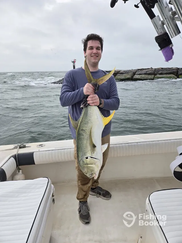 Angler holding a large Jack Crevalle from a coastal Galveston trip