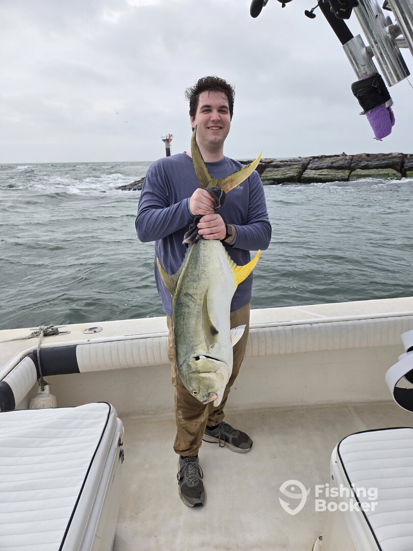 Angler holding a large Jack Crevalle from a coastal Galveston trip