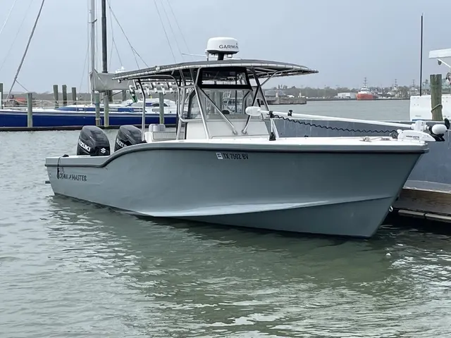 The 31 ft Ocean Master Half Time docked, twin Suzuki 300s mounted